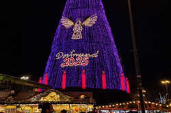 A big lit-up Christmas tree with an angel and Dortmund 2025 written on it.