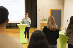 A person holds a speech in front of the scholarship recipients.