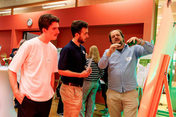  A researcher explains his project to two listeners.