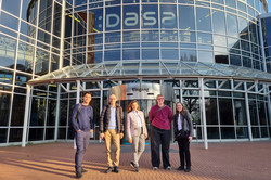 A group of people standing in front of the entrance of DASA.