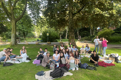 In the picture is a group that is having a picnic in a park.