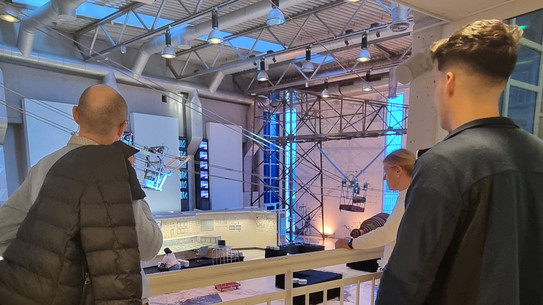 People looking into an industrial hall.