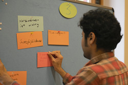 Midterm Meeting Tandem2Job 2024 Brainstoring: man pins card on pinboard