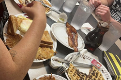 Hier sieht man eine Gruppe von Menschen bei Wafflehouse essen. 