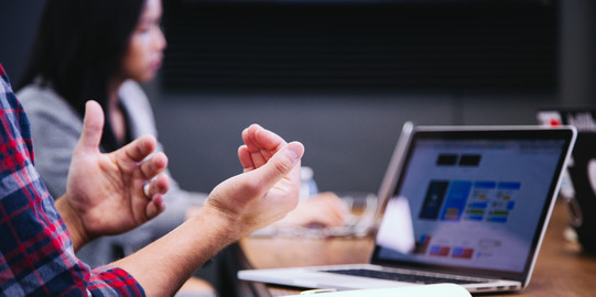 people at a table with laptop