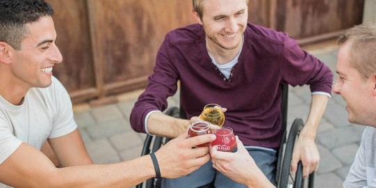 people in wheelchairs drinking together