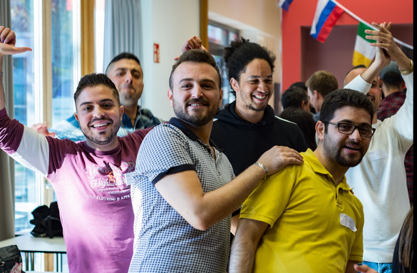a group of men in the International Meeting Centre of the TU Dortmund University, smiling into the camera 