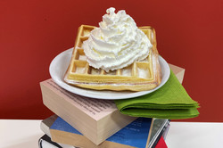 Waffle with cream on book tower