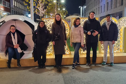 People standing in front of big lit-up letters spelling Dortmund.