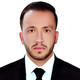 Testimonial Ibrahimi The portrait of a young man in a suit in front of a white background.