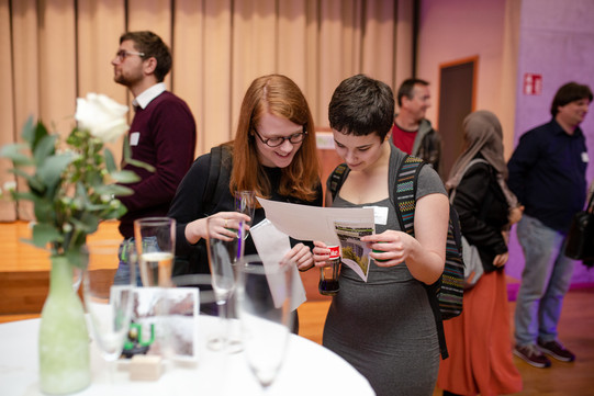 Two people look at a brochure together