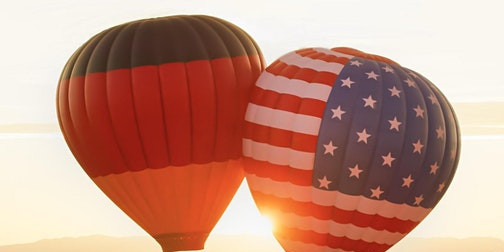 E_112021_Hasso-Plattner_cdn.evbuc.com_images_166610739.jpg 2 hot air balloons, one with the German flag and one with the US flag, float in the air