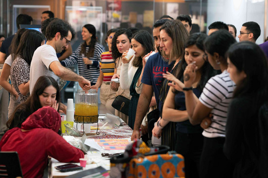 A group of people standing in front of a cultural stand