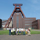 A group of people in front of the shaft tower at Zeche Zollverein. 