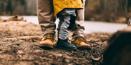 Feet of an adult and a child