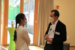 Tandem3Talking Mentee (left) in conversation with mentor (right); mentor holds mentoring guide in hand