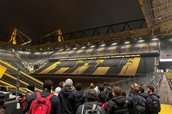 People are looking into a soccer stadium from the ranks.