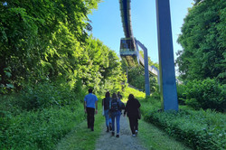 People walking below the H-Bahn.