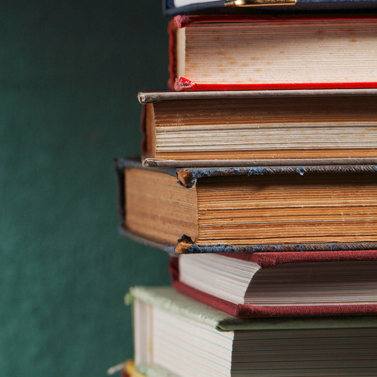 a pile of hardcovered books